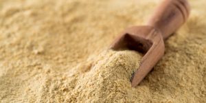 This image shows dry yeast and with a wooden scoop placed within